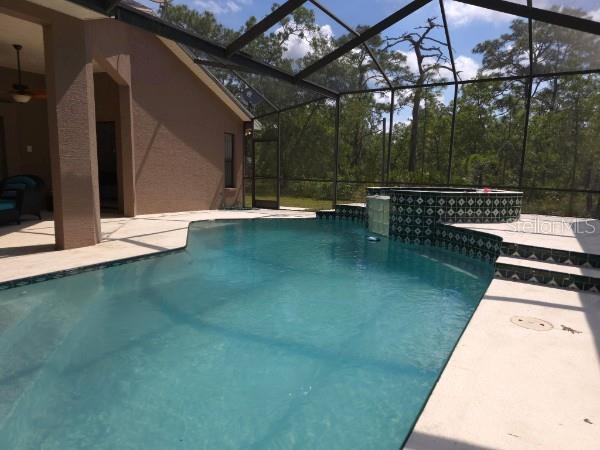 4710 W Mustang Blvd, Beverly Hills, FL 34465 - view of pool with a patio, a ceiling fan, a lanai, and a pool with connected hot tub