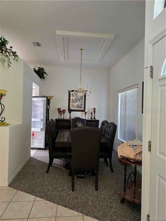 4710 W Mustang Blvd, Beverly Hills, FL 34465 - dining space featuring light colored carpet, a chandelier, light tile patterned flooring, and baseboards
