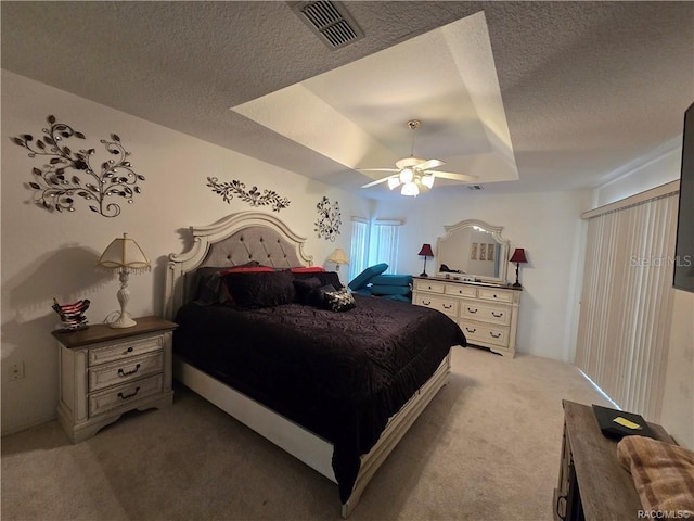 4710 W Mustang Blvd, Beverly Hills, FL 34465 - bedroom featuring carpet, a tray ceiling, a textured ceiling, and a ceiling fan