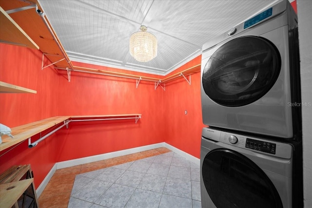 219 Marion Oaks Ln, Ocala, FL 34473 - washroom featuring stacked washer / drying machine, tile patterned floors, and baseboards