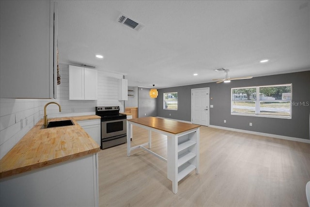 219 Marion Oaks Ln, Ocala, FL 34473 - kitchen with wood counters, electric range, a sink, open shelves, and recessed lighting