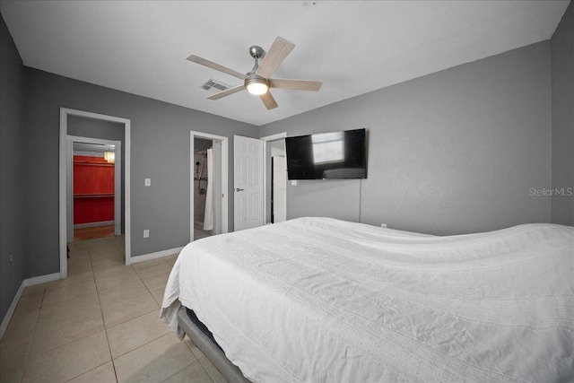 219 Marion Oaks Ln, Ocala, FL 34473 - bedroom with light tile patterned flooring, baseboards, a walk in closet, and a ceiling fan