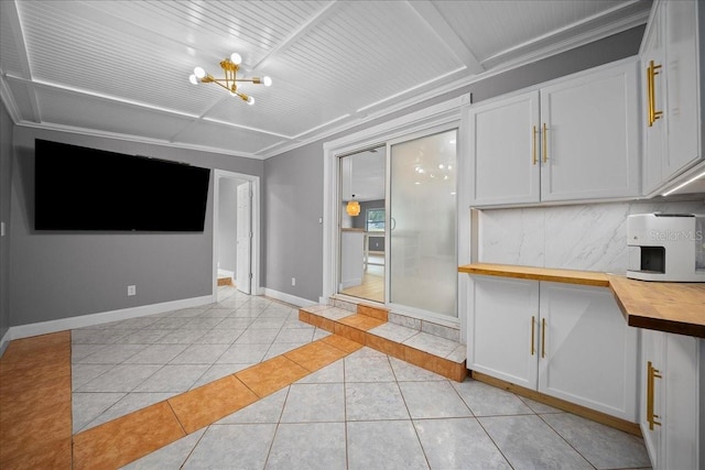 219 Marion Oaks Ln, Ocala, FL 34473 - kitchen featuring wood counters, light tile patterned floors, a chandelier, baseboards, and white cabinets