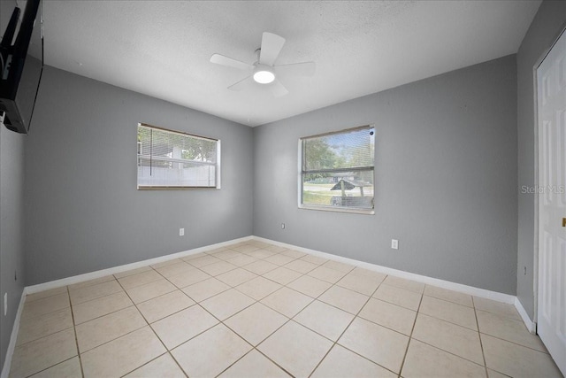 219 Marion Oaks Ln, Ocala, FL 34473 - spare room with ceiling fan, light tile patterned floors, a textured ceiling, and baseboards