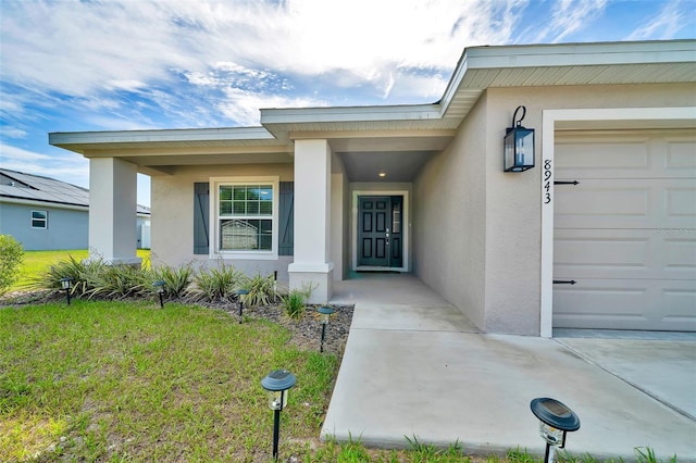 8943 SE 41st Court Rd, Ocala, FL 34480 - property entrance with a garage and stucco siding