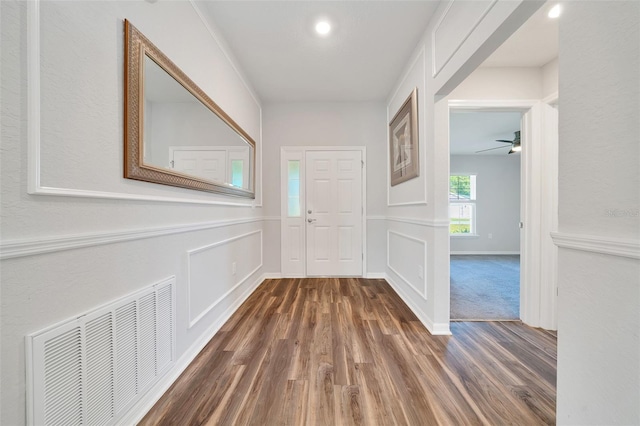 8943 SE 41st Court Rd, Ocala, FL 34480 - entrance foyer featuring wood finished floors, a decorative wall, ceiling fan, and wainscoting