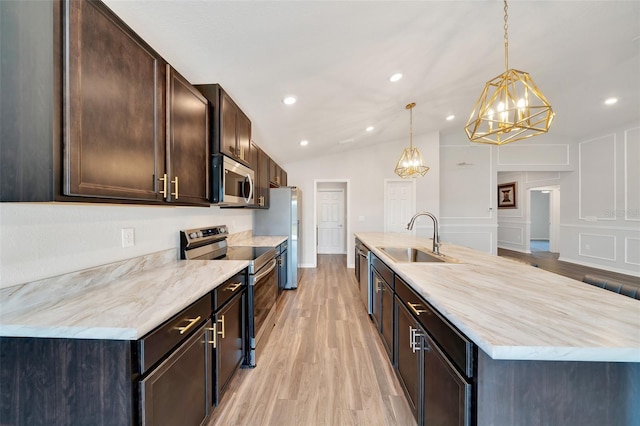 8943 SE 41st Court Rd, Ocala, FL 34480 - kitchen with a sink, appliances with stainless steel finishes, a chandelier, light wood-style floors, and dark brown cabinetry