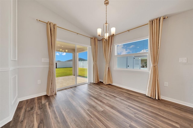 8943 SE 41st Court Rd, Ocala, FL 34480 - spare room with a chandelier, wood finished floors, lofted ceiling, and baseboards