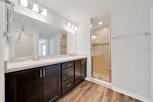 8943 SE 41st Court Rd, Ocala, FL 34480 - bathroom with double vanity, a shower stall, wood finished floors, baseboards, and recessed lighting