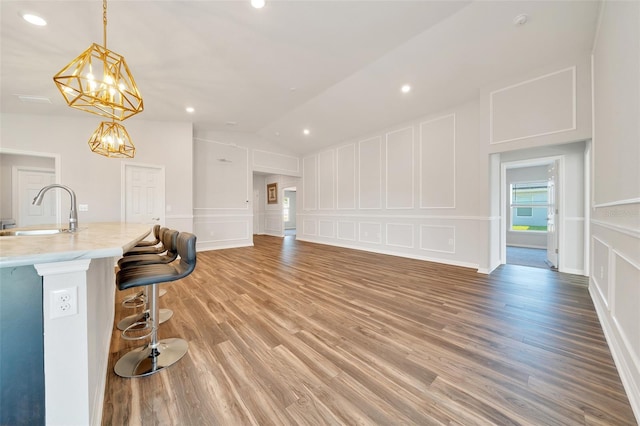 8943 SE 41st Court Rd, Ocala, FL 34480 - living area featuring a decorative wall, lofted ceiling, light wood-type flooring, recessed lighting, and a chandelier