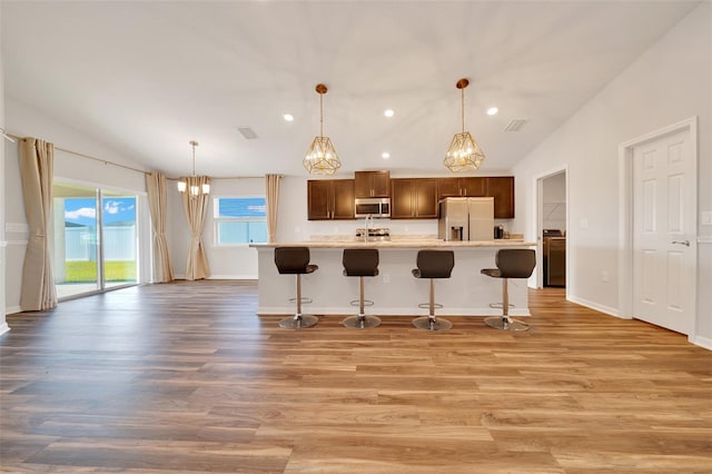 8943 SE 41st Court Rd, Ocala, FL 34480 - kitchen with stainless steel appliances, lofted ceiling, light countertops, a chandelier, and recessed lighting