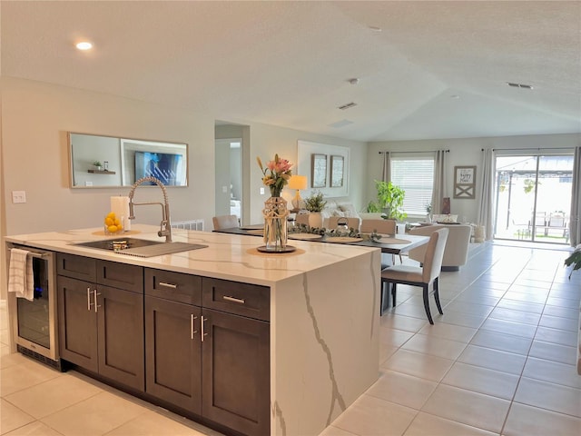 5667 SW 92nd Pl, Ocala, FL 34476 - kitchen with a sink, open floor plan, wine cooler, light tile patterned floors, and light stone counters