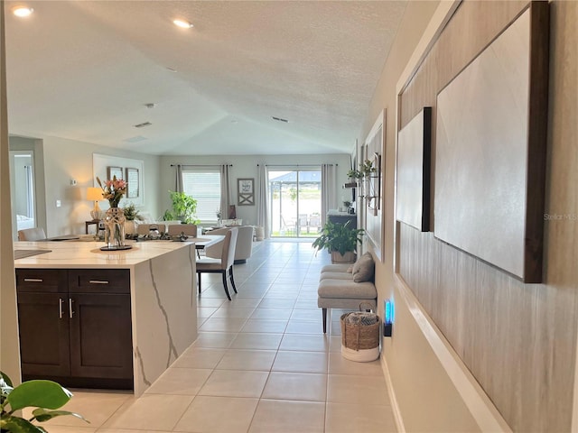 5667 SW 92nd Pl, Ocala, FL 34476 - kitchen featuring lofted ceiling, light tile patterned floors, dark brown cabinets, open floor plan, and recessed lighting