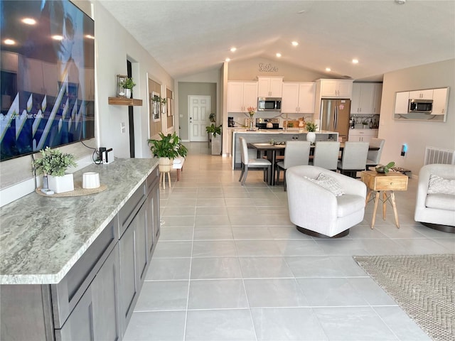 5667 SW 92nd Pl, Ocala, FL 34476 - living area featuring lofted ceiling and light tile patterned floors