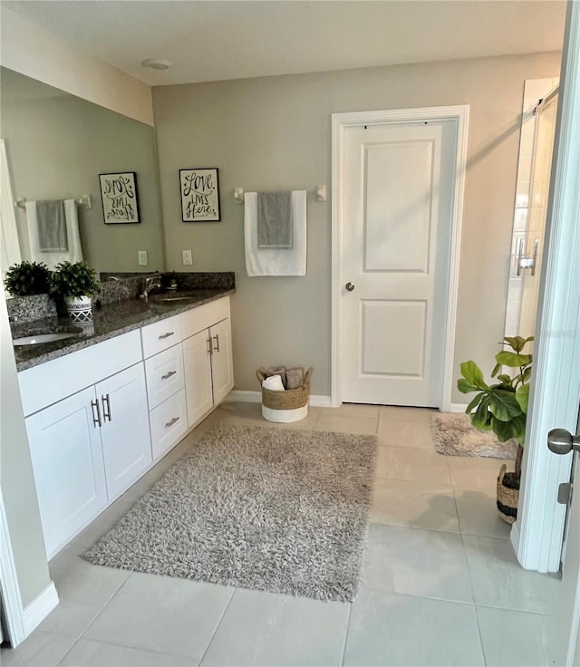 5667 SW 92nd Pl, Ocala, FL 34476 - bathroom with double vanity, baseboards, tile patterned flooring, and an enclosed shower