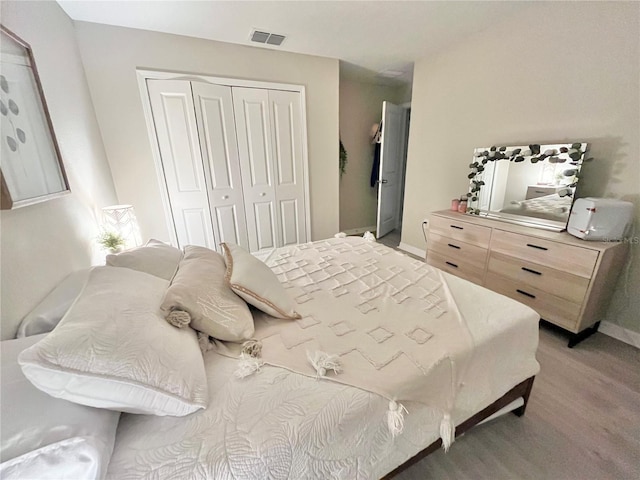 5667 SW 92nd Pl, Ocala, FL 34476 - bedroom featuring a closet, light wood-style floors, and baseboards
