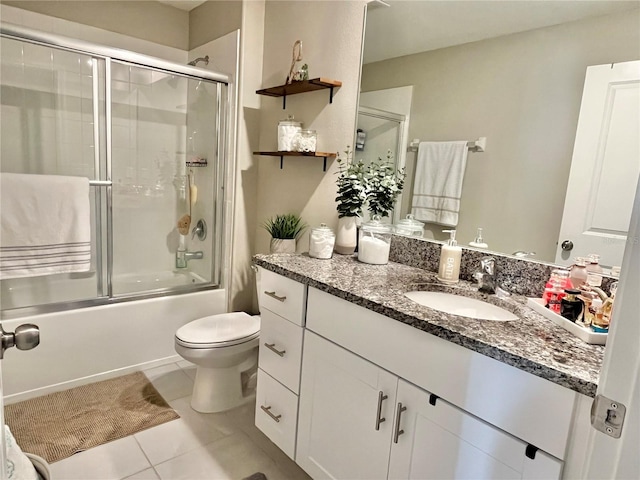 5667 SW 92nd Pl, Ocala, FL 34476 - bathroom featuring vanity, toilet, tile patterned floors, and shower / bath combination with glass door