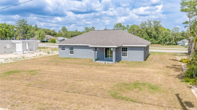 400 Marion Oaks Crse, Ocala, FL 34473 - rear view of property featuring a lawn, stucco siding, and a shingled roof