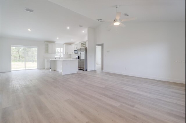 400 Marion Oaks Crse, Ocala, FL 34473 - unfurnished living room with ceiling fan, recessed lighting, baseboards, a sink, and light wood-style floors