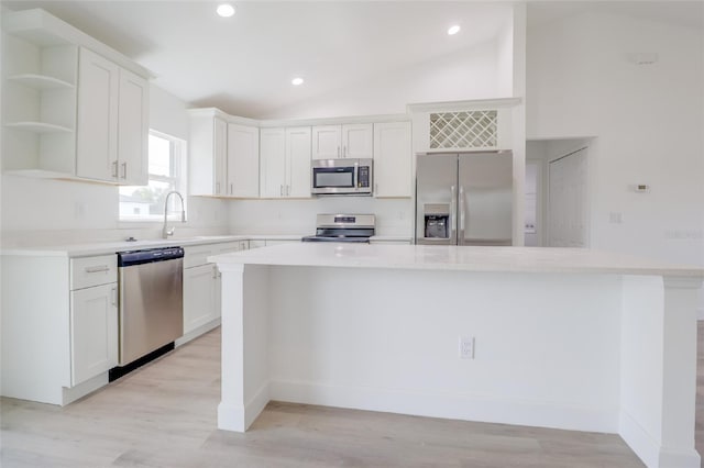 400 Marion Oaks Crse, Ocala, FL 34473 - kitchen with appliances with stainless steel finishes, a kitchen island, a sink, light countertops, and white cabinets