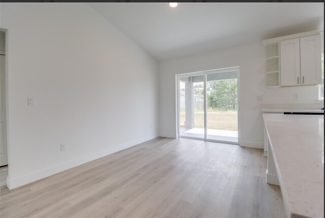 400 Marion Oaks Crse, Ocala, FL 34473 - unfurnished dining area featuring lofted ceiling, light wood-style flooring, and baseboards