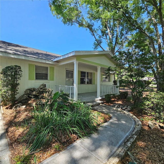 8635 SW 95th St Unit G, Ocala, FL 34481 - view of side of property featuring a porch and a shingled roof
