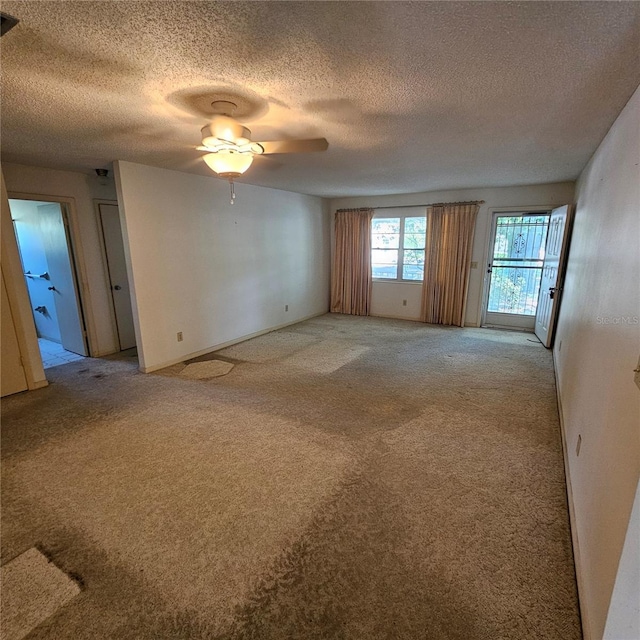 8635 SW 95th St Unit G, Ocala, FL 34481 - empty room with light colored carpet, ceiling fan, and a textured ceiling