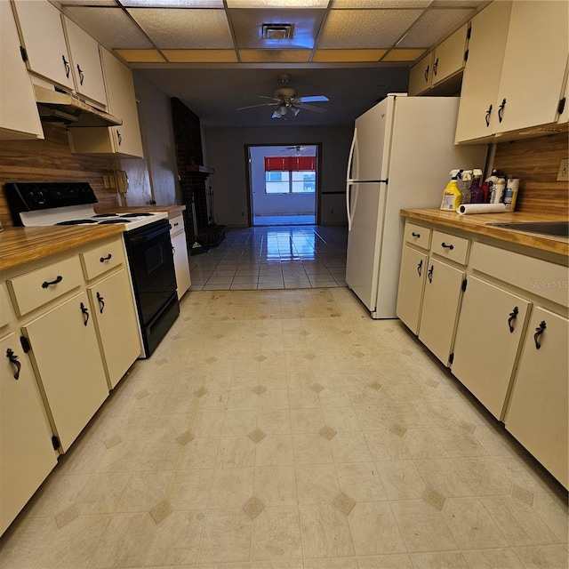 8635 SW 95th St Unit G, Ocala, FL 34481 - kitchen featuring black range with electric stovetop, under cabinet range hood, a ceiling fan, a paneled ceiling, and tasteful backsplash