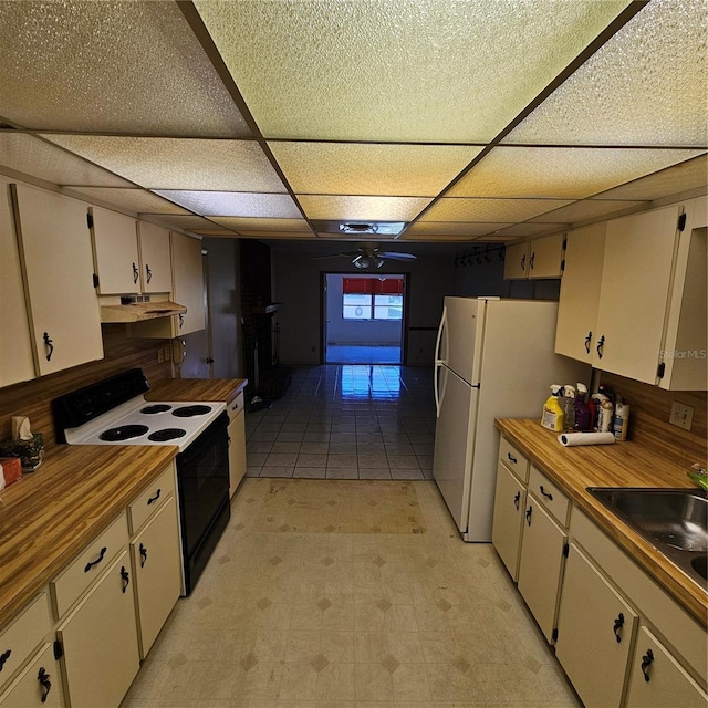 8635 SW 95th St Unit G, Ocala, FL 34481 - kitchen with electric stove, under cabinet range hood, a sink, a drop ceiling, and light floors