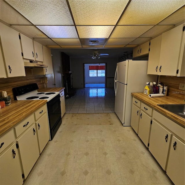 8635 SW 95th St Unit G, Ocala, FL 34481 - kitchen featuring electric stove, under cabinet range hood, a drop ceiling, ceiling fan, and freestanding refrigerator