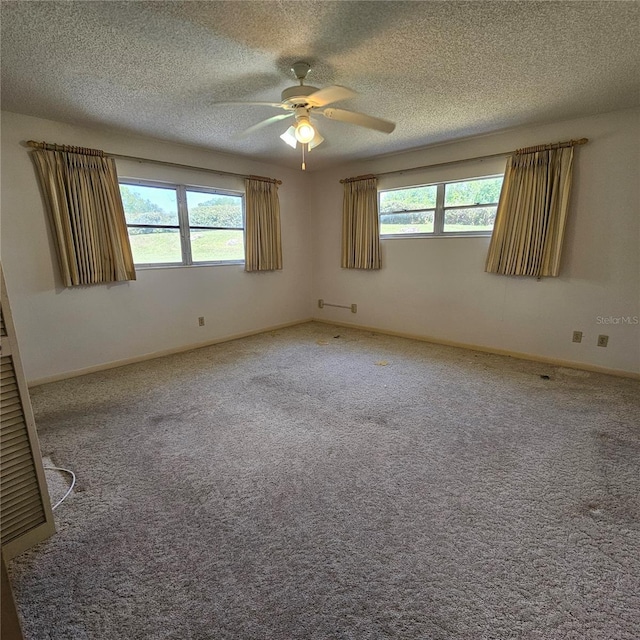 8635 SW 95th St Unit G, Ocala, FL 34481 - empty room featuring a ceiling fan, carpet floors, a textured ceiling, and baseboards