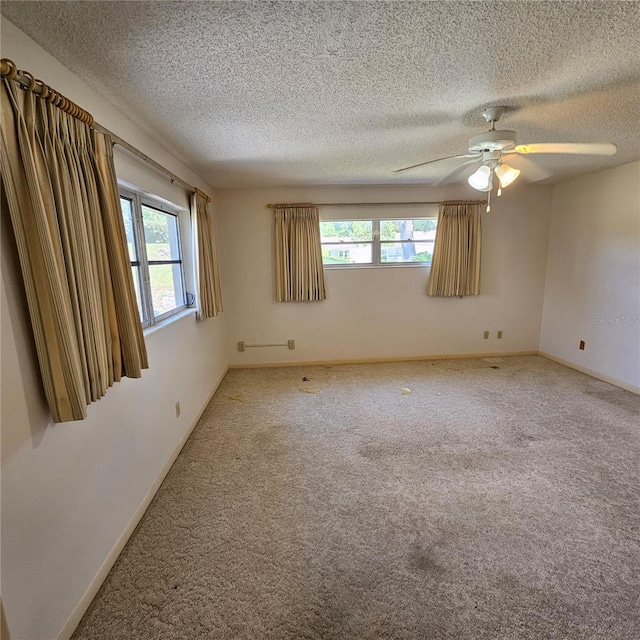 8635 SW 95th St Unit G, Ocala, FL 34481 - carpeted empty room featuring healthy amount of natural light, a ceiling fan, a textured ceiling, and baseboards