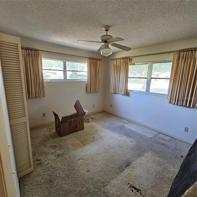8635 SW 95th St Unit G, Ocala, FL 34481 - unfurnished bedroom featuring multiple windows, carpet, a textured ceiling, and baseboards