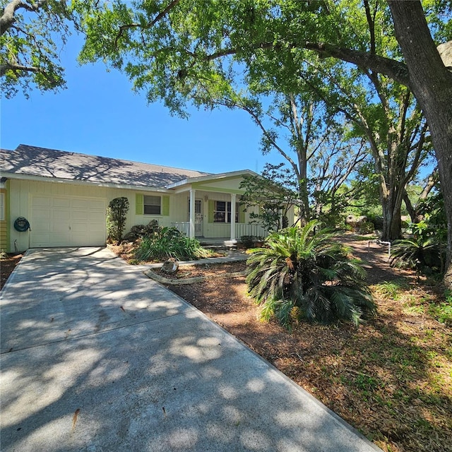 8635 SW 95th St Unit G, Ocala, FL 34481 - view of front of property with a garage, a porch, and driveway