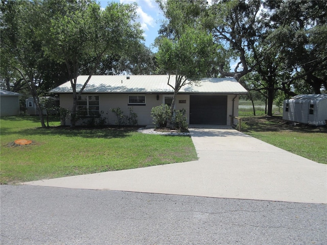 1675 SE 190th Ave, Silver Springs, FL 34488 - ranch-style house featuring a garage, driveway, a front lawn, and metal roof