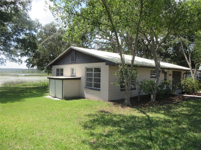 1675 SE 190th Ave, Silver Springs, FL 34488 - view of property exterior featuring a yard, a water view, and a garage
