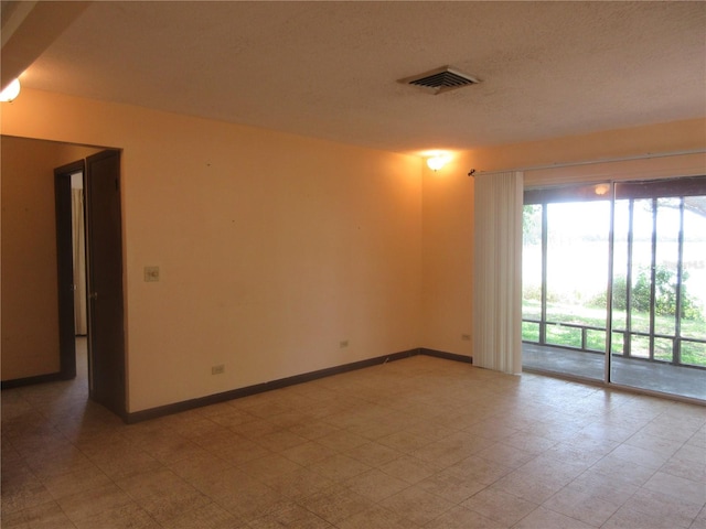 1675 SE 190th Ave, Silver Springs, FL 34488 - empty room with baseboards and a textured ceiling