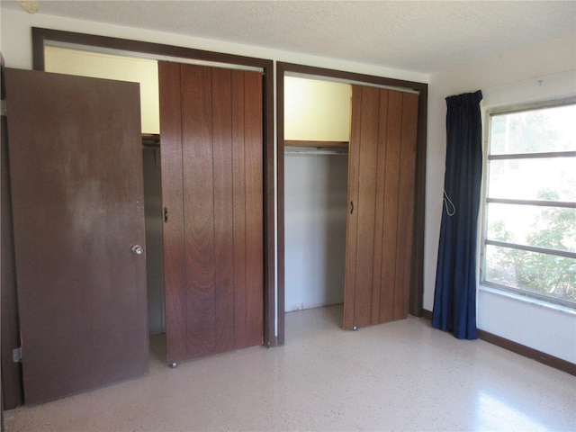 1675 SE 190th Ave, Silver Springs, FL 34488 - unfurnished bedroom with baseboards and dark speckled floor