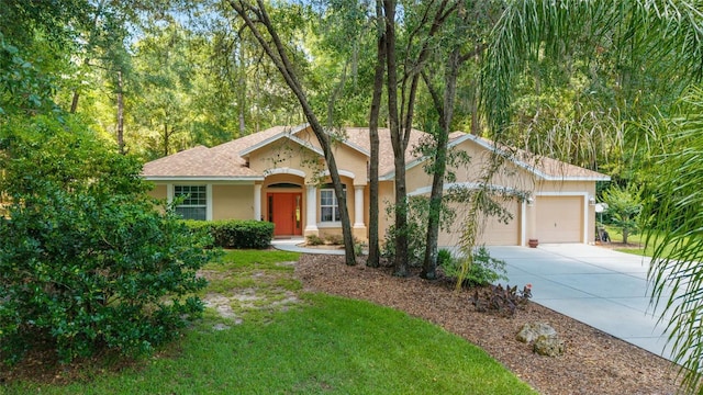 18328 SW 73rd Loop, Dunnellon, FL 34432 - single story home with a garage, driveway, stucco siding, and roof with shingles