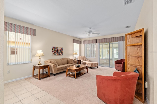 9408 SE 132nd Loop, Summerfield, FL 34491 - living room featuring plenty of natural light, baseboards, ceiling fan, and light colored carpet