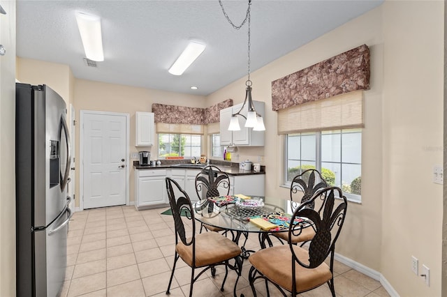 9408 SE 132nd Loop, Summerfield, FL 34491 - dining room with light tile patterned floors, baseboards, and a textured ceiling