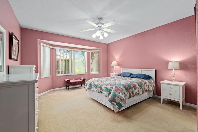 9408 SE 132nd Loop, Summerfield, FL 34491 - bedroom featuring light carpet, baseboards, and ceiling fan