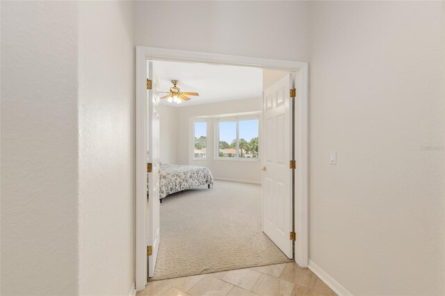 13495 SE 93rd Court Rd, Summerfield, FL 34491 - corridor featuring light carpet, baseboards, and light tile patterned flooring