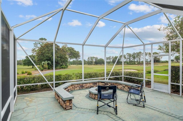 13495 SE 93rd Court Rd, Summerfield, FL 34491 - view of patio featuring golf course view, glass enclosure, and an outdoor fire pit