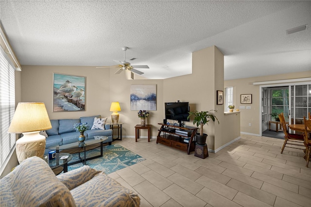 8137 SW 117th Loop, Ocala, FL 34481 - living area featuring ceiling fan, a textured ceiling, lofted ceiling, baseboards, and light tile patterned floors