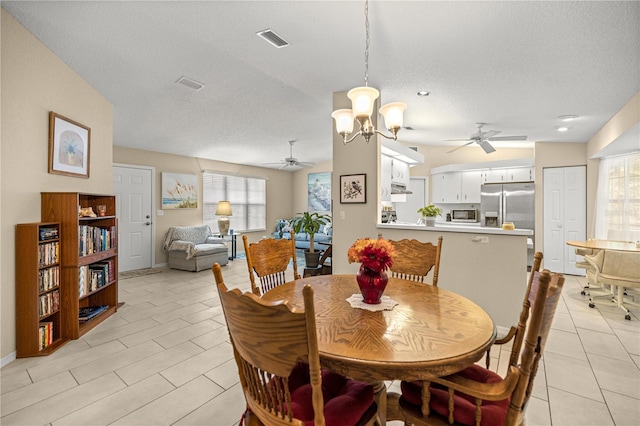 8137 SW 117th Loop, Ocala, FL 34481 - dining area with ceiling fan, healthy amount of natural light, a chandelier, a textured ceiling, and light tile patterned floors