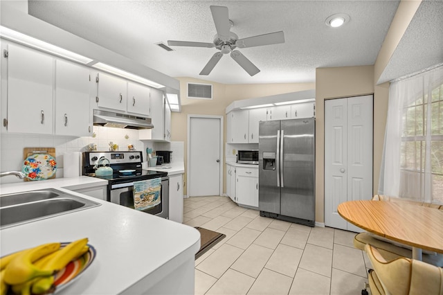 8137 SW 117th Loop, Ocala, FL 34481 - kitchen with stainless steel appliances, under cabinet range hood, a sink, light countertops, and tasteful backsplash