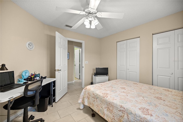 8137 SW 117th Loop, Ocala, FL 34481 - bedroom featuring two closets, an office area, light tile patterned floors, a textured ceiling, and a ceiling fan