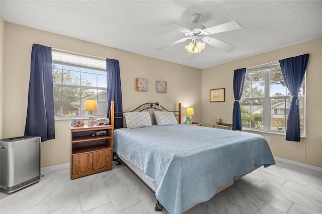 8137 SW 117th Loop, Ocala, FL 34481 - bedroom featuring marble finish floors, multiple windows, a textured ceiling, and ceiling fan