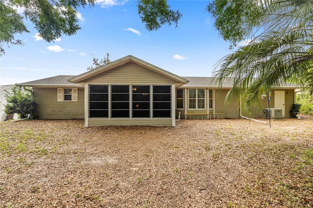 8137 SW 117th Loop, Ocala, FL 34481 - rear view of property featuring cooling unit, a sunroom, and a shingled roof